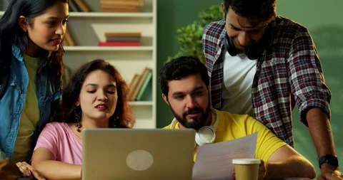 Using laptop to complete assignment Indian students studying together in library Video stock 342383138