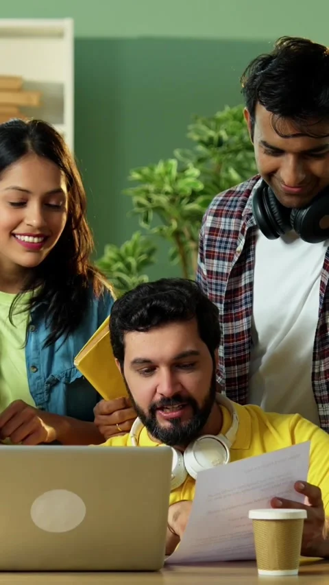 Using laptop to complete assignment Indian students studying together in library Stock Footage 342385000