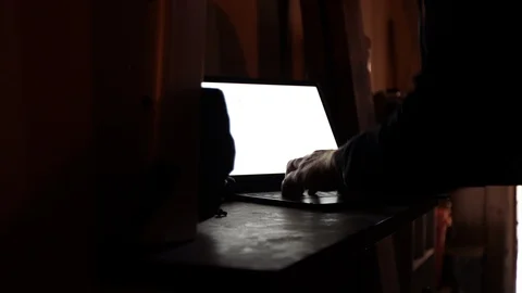 Using laptop computer in garage sneaky hacker Stock Footage 111347547