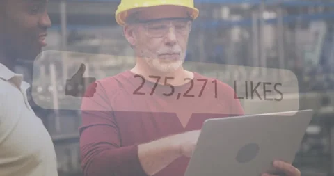 Using laptop, factory worker with hard hat and glasses, social media likes 動画素材 305292293