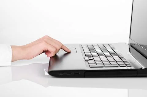 Using a laptop, a finger on touchpad 스톡 사진