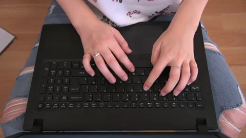 Using Laptop on Floor Sitting Cross-Legged Stock Footage 138219503