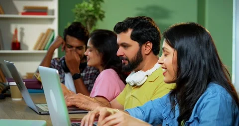 Using laptop, Indian students focus on group study with books and notes Stock-Footage 342383557