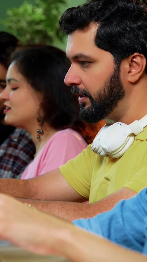 Using laptop, Indian students focus on group study with books notes in library Stock Footage 342385031