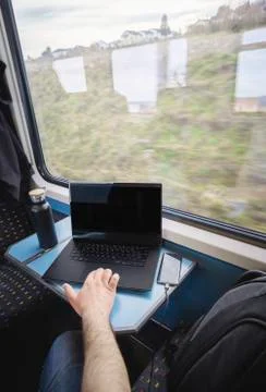 Using laptop on train travel. Train interior. Business commuting Stock Photos