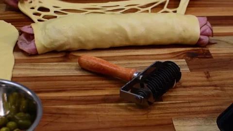 Using a lattice dough roller cutter to create a decorative mesh pattern in Stock Footage 328389292