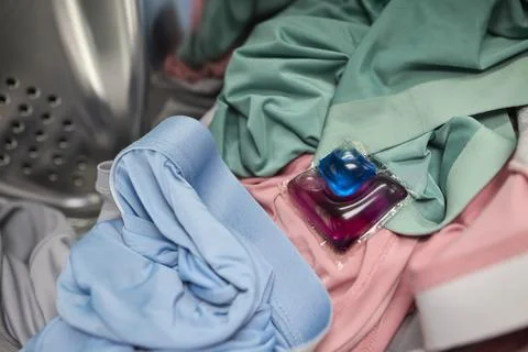 Using Laundry Detergent Pods While Doing Laundry in the Washing Machine with Stock Photos
