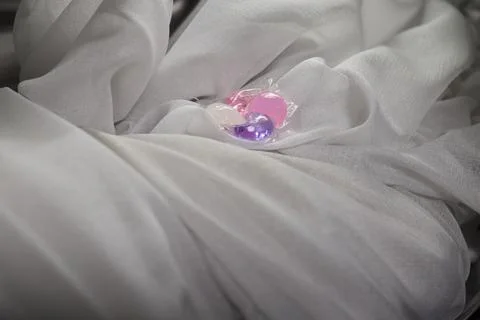 Using Laundry Detergent Pods While Doing Laundry in the Washing Machine with Stock Photos