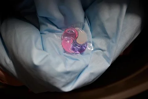 Using Laundry Detergent Pods While Doing Laundry in the Washing Machine with Stock Photos