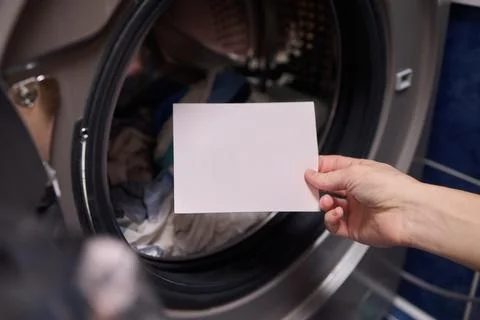 Using Laundry Detergent Pods While Doing Laundry in the Washing Machine with Stock Photos