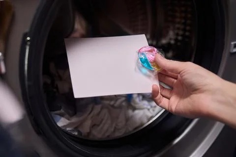 Using Laundry Detergent Pods While Doing Laundry in the Washing Machine with Stock Photos