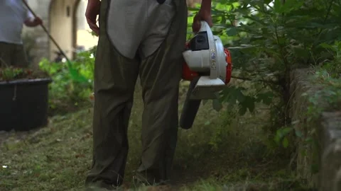 Using a leaf blower in slowmotion Stock Footage 248211718