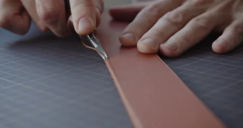 Using leather edge beveler during belt manufacturing process close-up Stock Footage 144891789