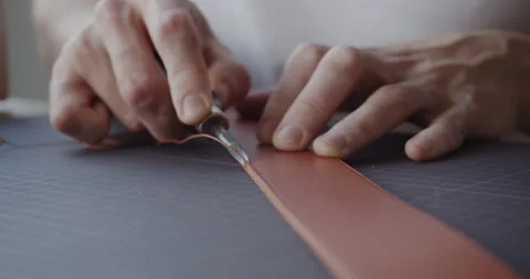 Using leather edge beveler during belt manufacturing process close-up Stock Footage 146135259