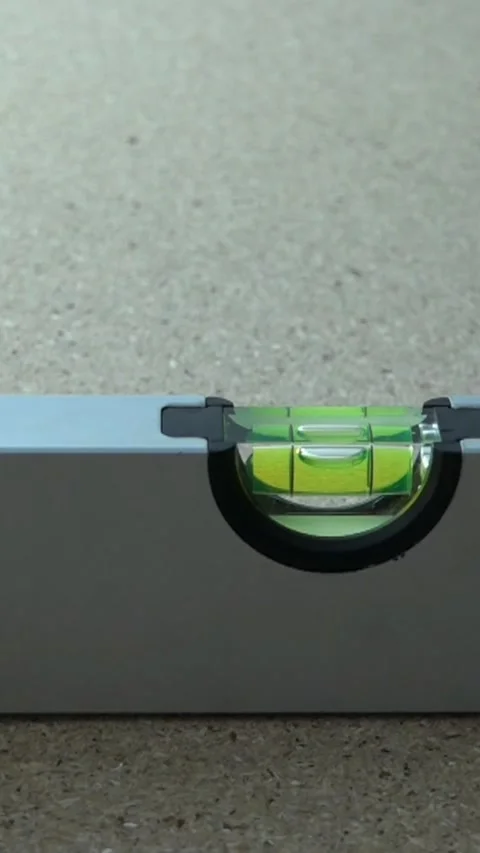 Using a level tool to check the straightness of a surface during a home project  Stock Footage 328939368