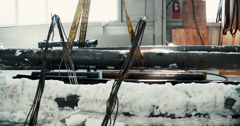 Using lifting machines to move metal pipe in a sheet metal factory. Stock Footage 167023817
