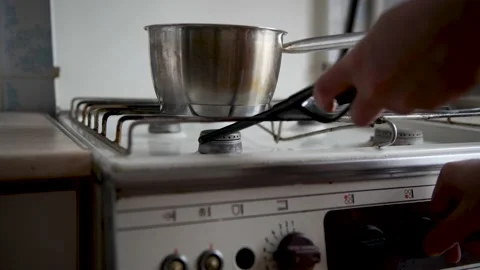 Using a lighter to create a flame on a gas stove. Stock Footage 183274191