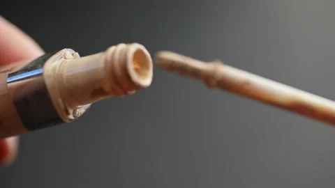 Using a liquid cosmetic foundation with a brush, applicator, close-up. Opening Stock Footage 162913809