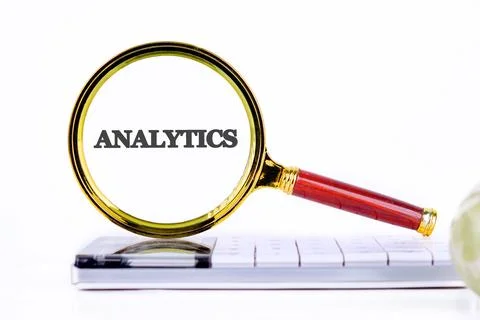 Using a magnifying glass to emphasize the importance of analytics in technolo Stock Photos