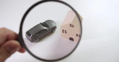 Using a magnifying glass, an individual is showing investment Stock Footage 254015260
