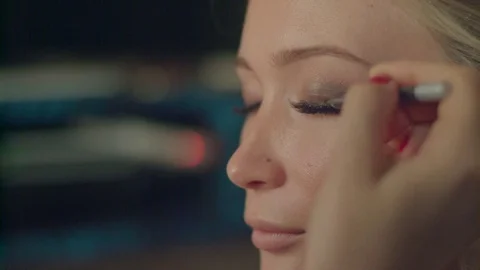 Using make up shadow pencil to conceal false eyelashes knots painting eyelid Stock Footage 71707508
