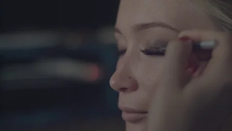 Using make up shadow pencil to conceal false eyelashes knots painting eyelid Stock Footage 71707955