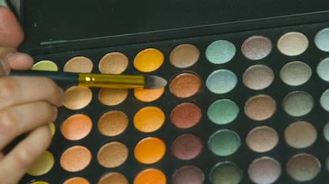 Using a makeup brush to get makeup ready for application Video stock 63864843
