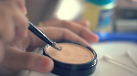 Using makeup powder and brush. 4k UHD (3840x2160) Stock Footage 60975003
