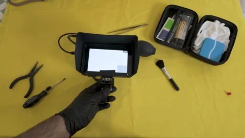 Using a manual air blower to clean the camera sensor area. Stock Footage 327624274