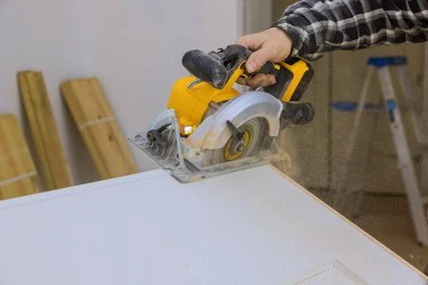 Using a manual circular saw, interior doors must be cut to required size before Foto stock