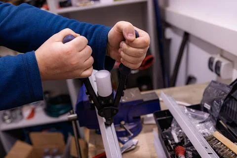 Using Manual Rivet Tool to Fasten Metal Profile, Hand Tool Installation Work in 库存照片