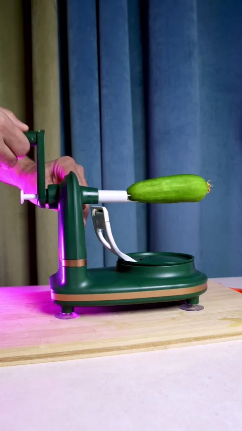 Using Manual Rotary Cucumber Peeler Kitchen Gadget Stock Footage 345452205