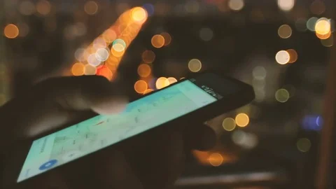 Using map app on phone against blurred Stock Footage 72816110