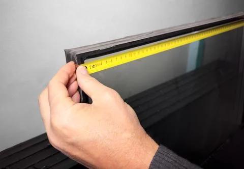 Using measurement tape, measuring tool for glass. Home construction Stock Photos