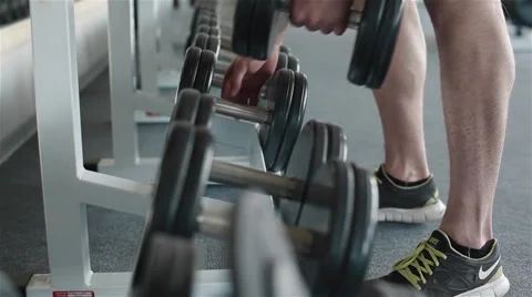 Using metal barbells fixed on stall. Close-up Stock Footage 49162303