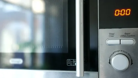 Using Microwave close up. Taking meal pot out Stock Footage 231656063