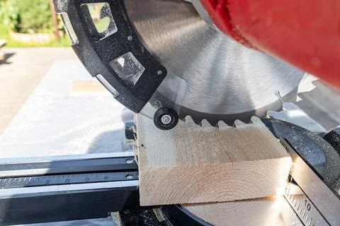 Using a miter saw to cut a piece of wood. Own carpentry workshop. Sawing a wo Stock Photos