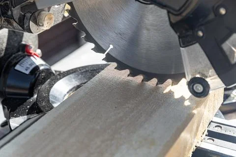 Using a miter saw to cut a piece of wood. Own carpentry workshop. Sawing a wo Stock Photos