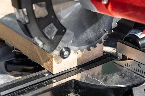 Using a miter saw to cut a piece of wood. Own carpentry workshop. Sawing a wo Stock Photos