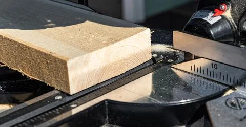 Using a miter saw to cut a piece of wood. Own carpentry workshop. Sawing a wo Stock Photos
