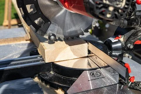 Using a miter saw to cut a piece of wood. Own carpentry workshop. Sawing a wo Stock Photos