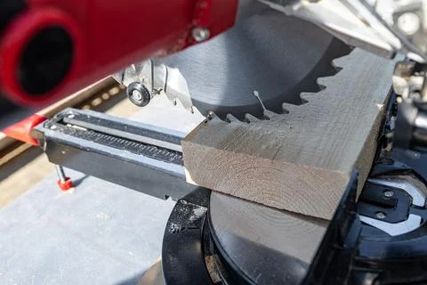Using a miter saw to cut a piece of wood. Own carpentry workshop. Sawing a wo Stock Photos