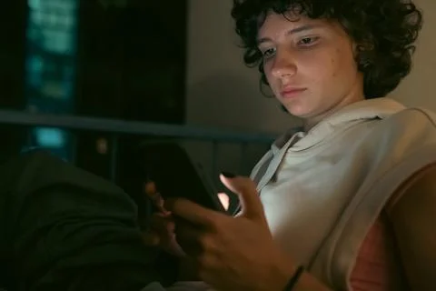 Using mobile apps technology on cell phone late at night Stock Photos