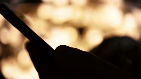 Using mobile on dark with blurred lightings on background Stock Footage 167010643