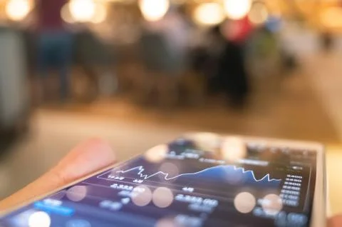 Using a mobile device to check market data Stock Photos