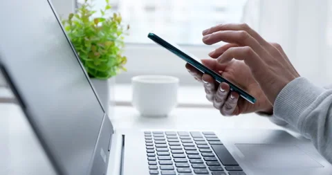 Using a mobile phone and laptop. Woman buys in an online store with a smartphone Vídeo Stock 150711117