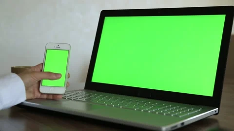 Using Mobile Phone and Laptop Green Screen Stock Footage 338122030