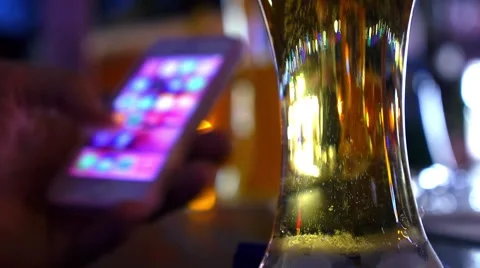 Using Mobile Phone with Beer Glass at Bar Counter 스톡 동영상 55667703