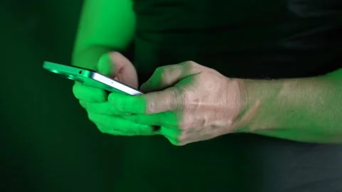Using a mobile phone in a bright neon light, close-up Stock Footage 272156256