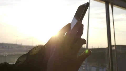 Using the mobile phone during sunset Stock Footage 239019631